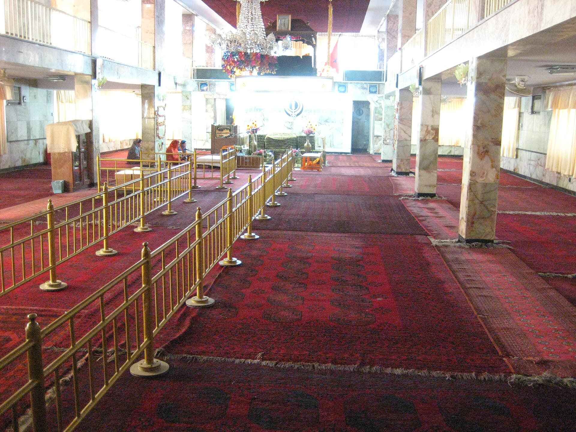 Afghan carpets and golden railings in the darbar hall of Gurdwara Karte Parwan
