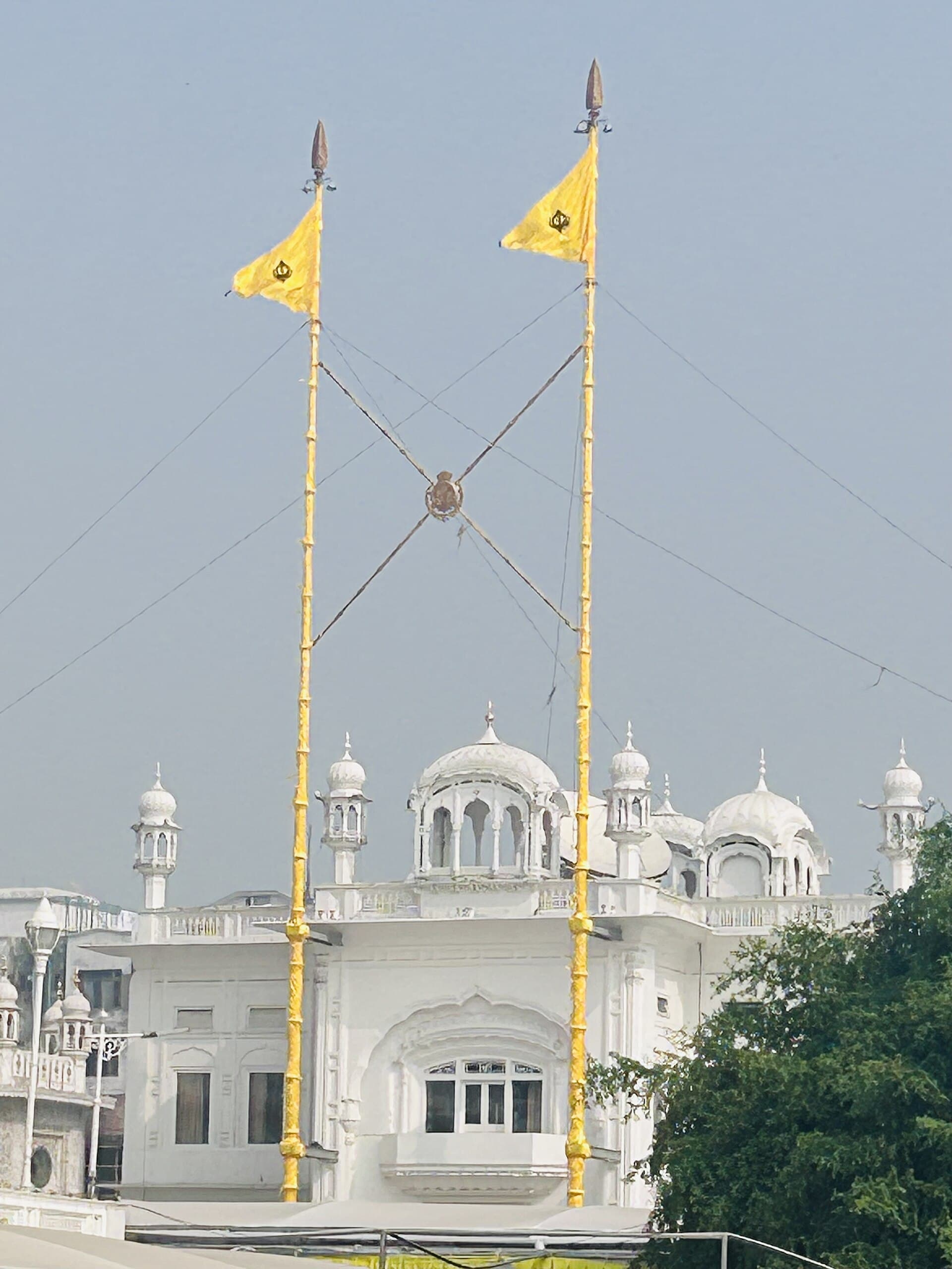 Twin nishan sahibs of miri and piri against the sky